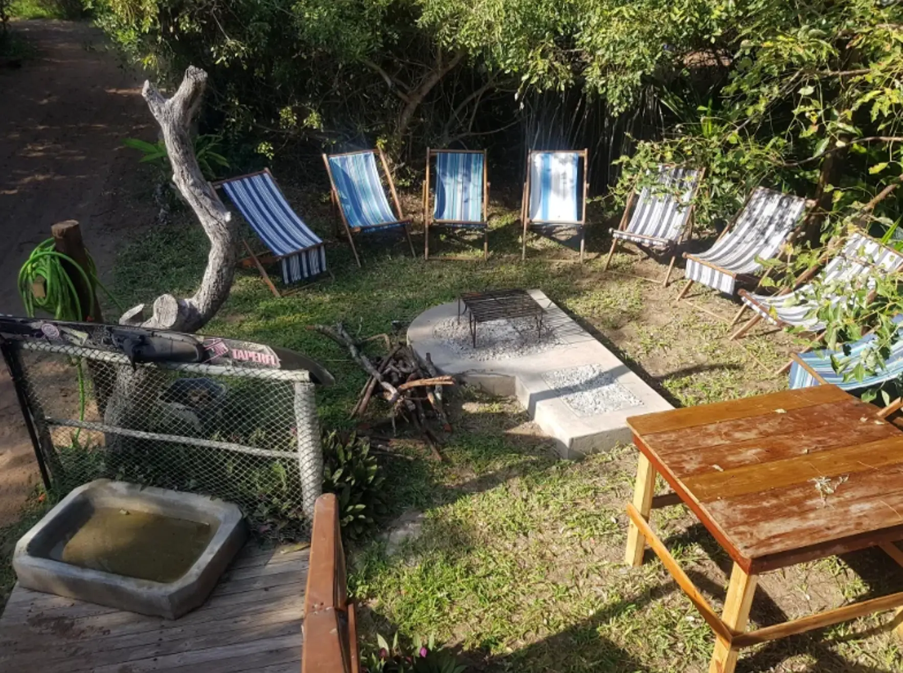 Outdoor braai area with deck chairs and fire pit