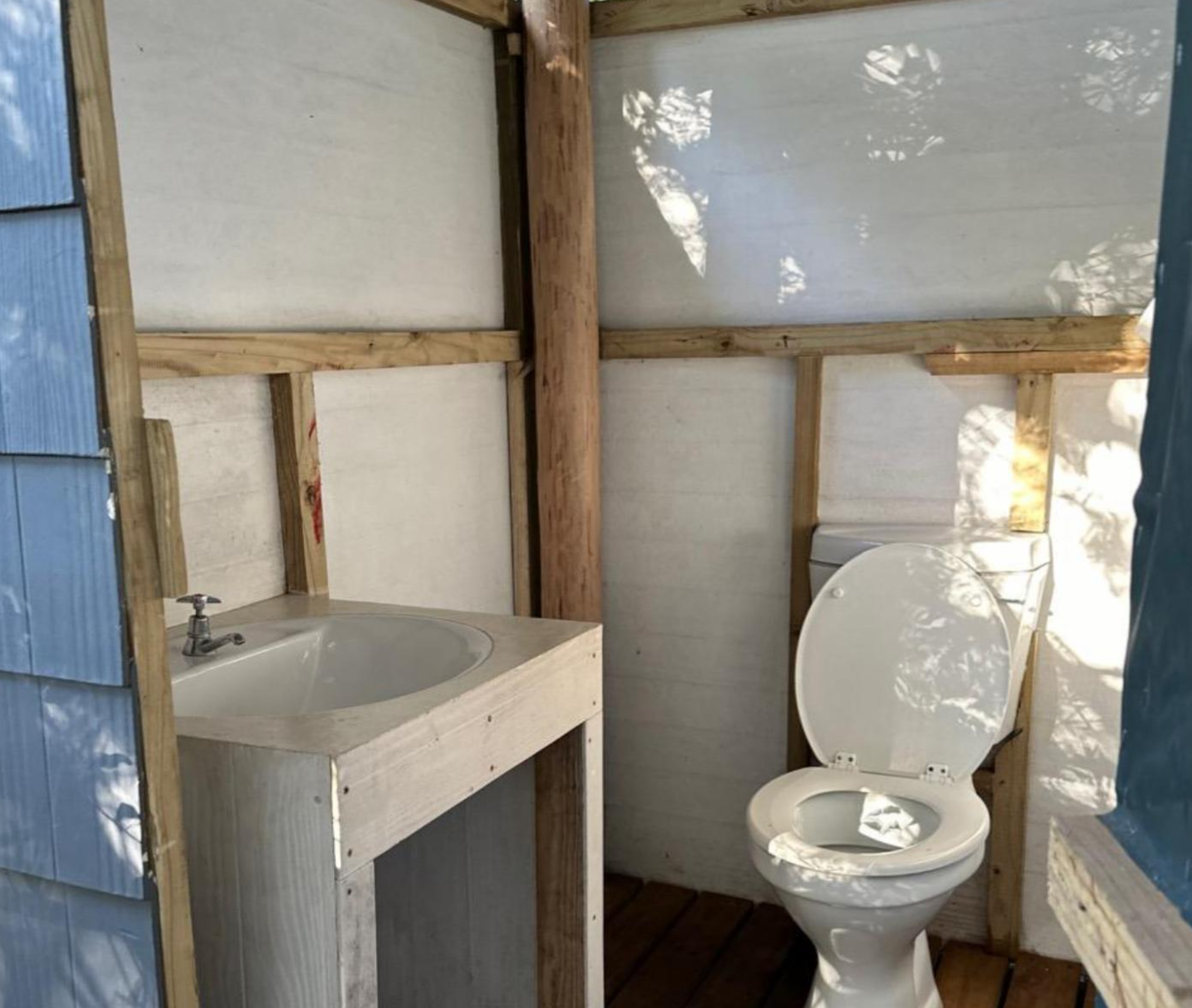 Private ablution cabin interior with toilet and basin