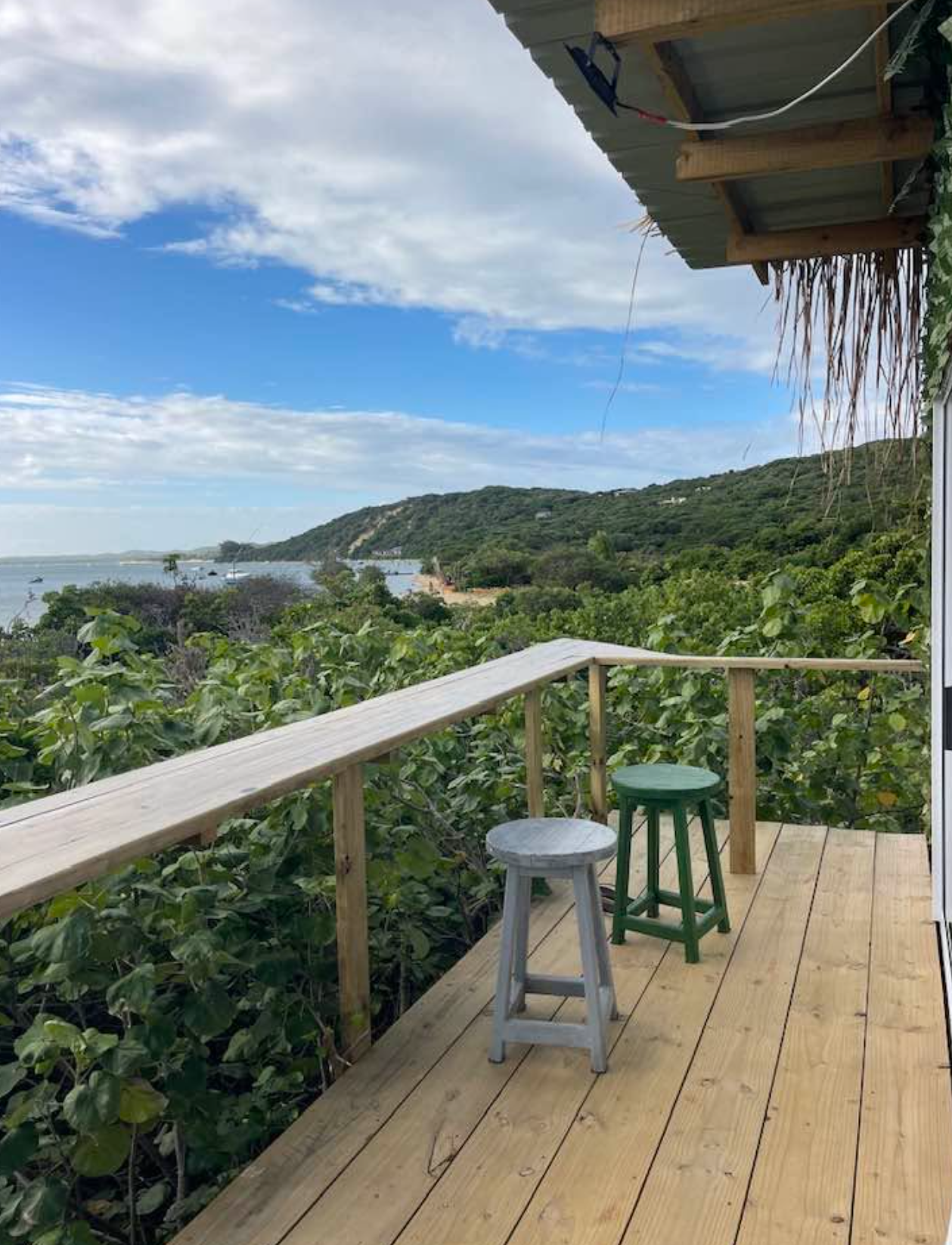 Upper deck with stools and sweeping Maputo Bay views