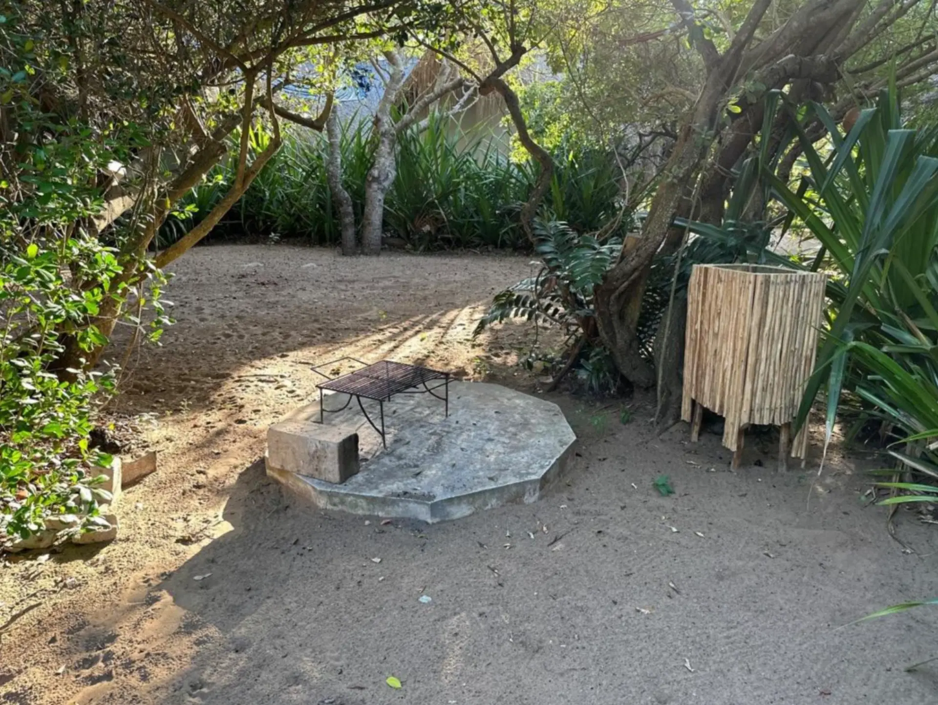 Campsite braai area with metal grid and concrete base