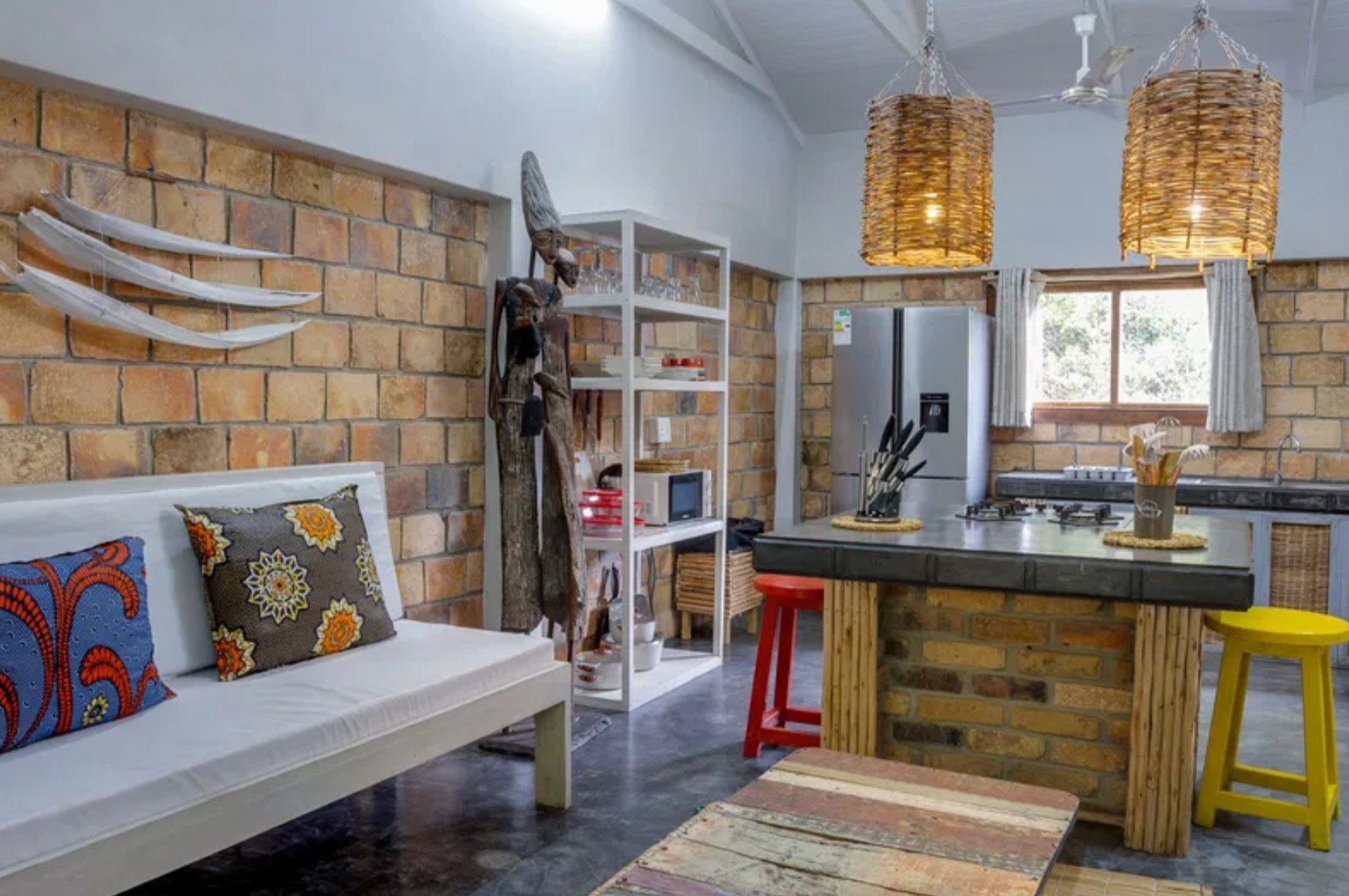 Open-plan kitchen with island counter and woven pendant lights