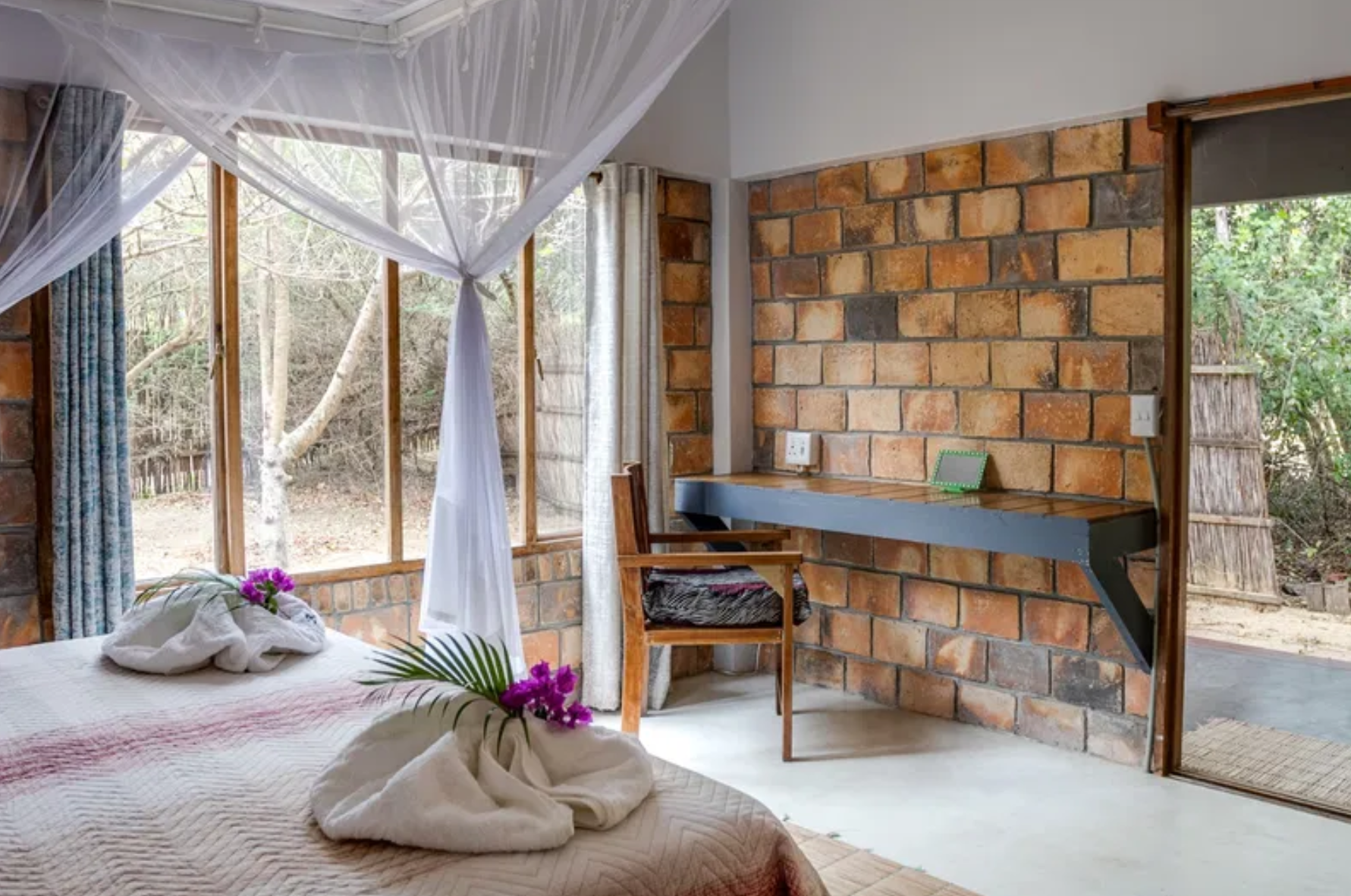 Bedroom with brick walls and garden view