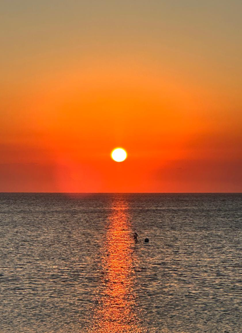 Golden sunset over Maputo Bay reflected on calm water