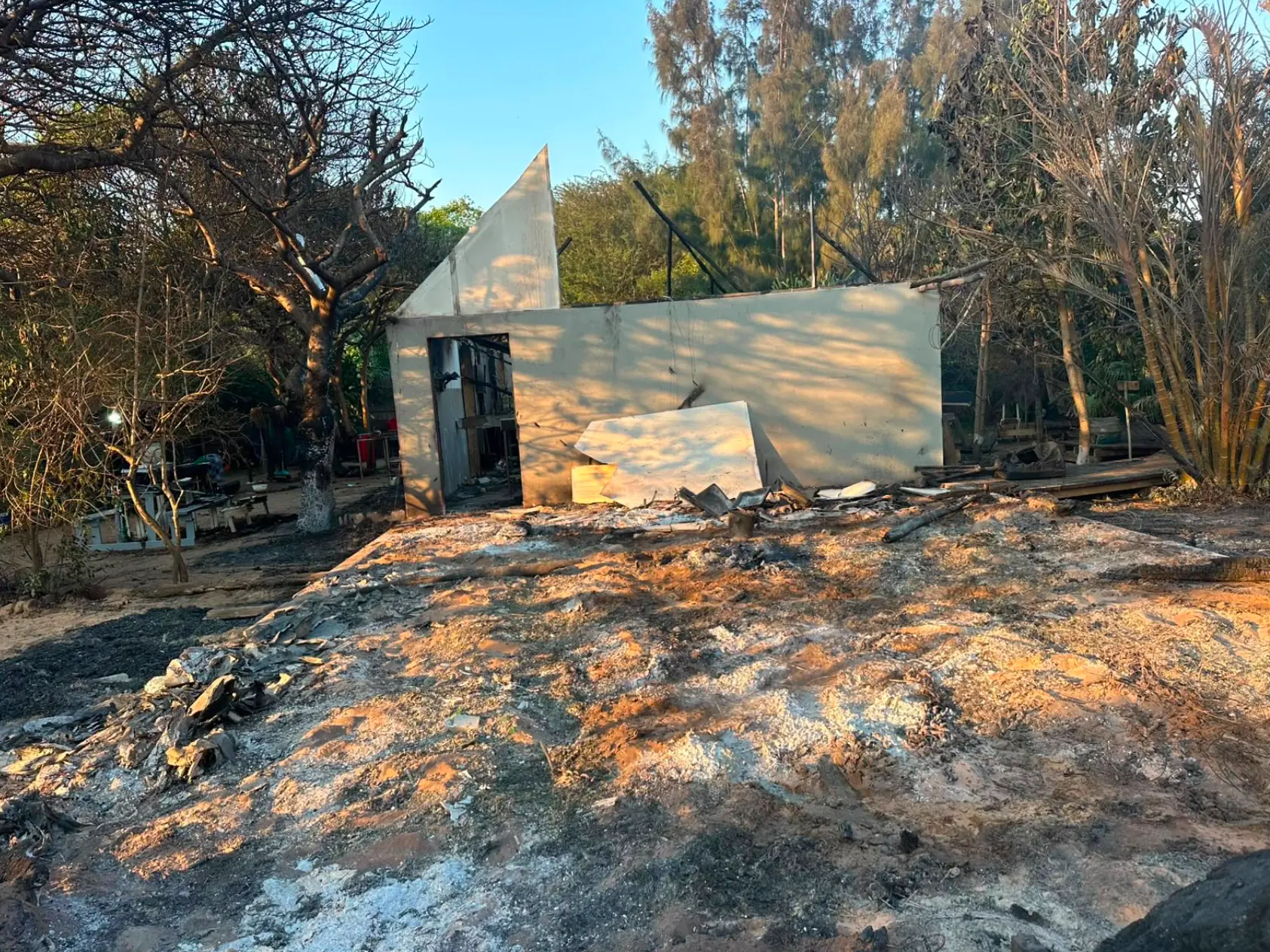 The fire-damaged building exterior at sunset