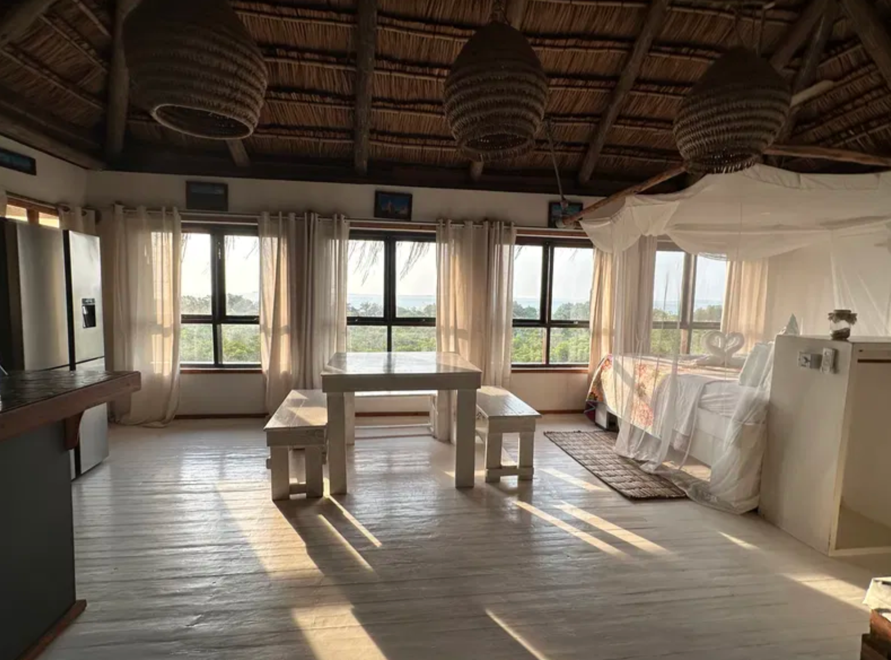 Upstairs dining table and kitchen with sea views