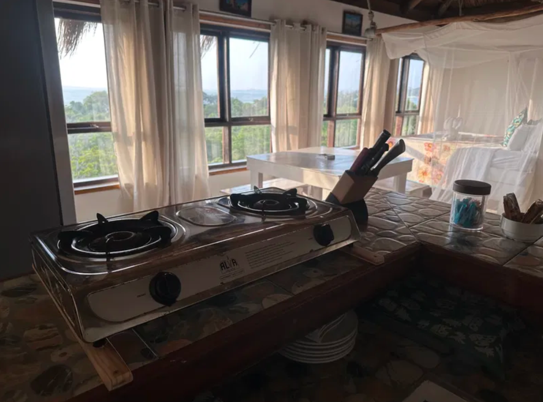 Upper-level kitchen with gas stove and bay-view windows