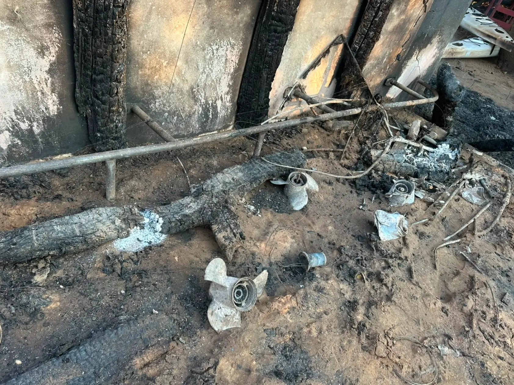 Burnt pipes and boat propellers in the sand