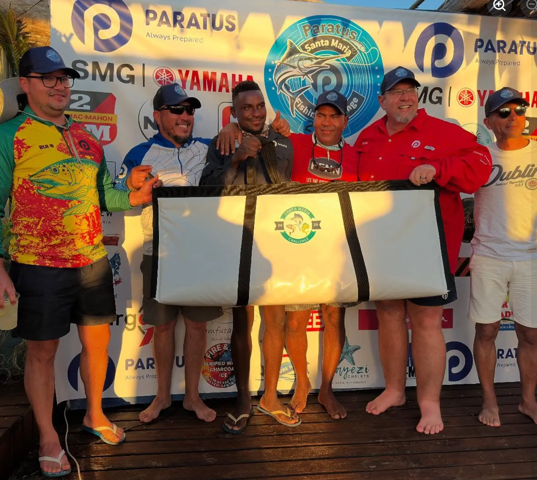 Competitors celebrating with a prize at the Santa Maria fishing competition