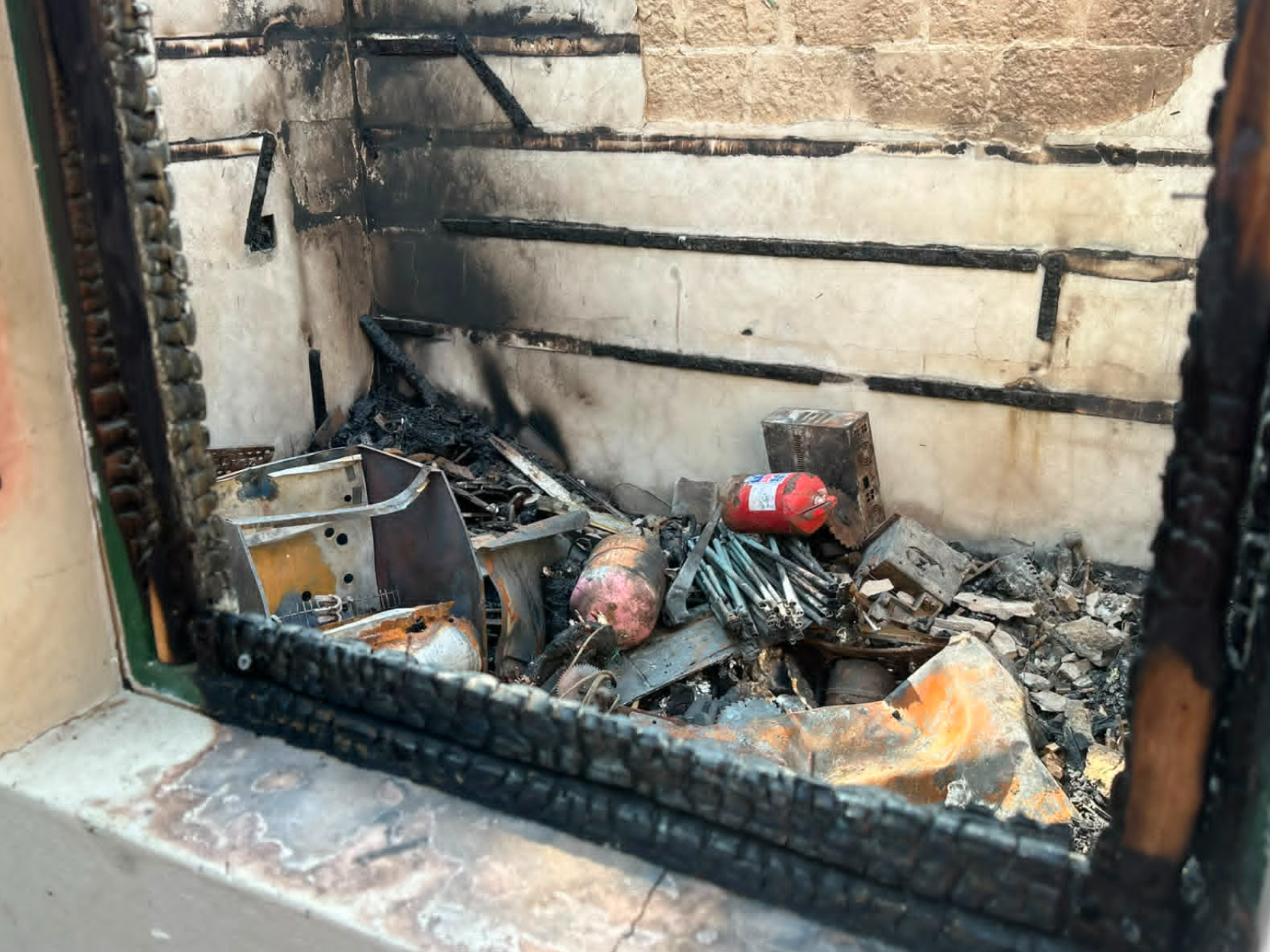 Fire-damaged kitchen equipment and debris