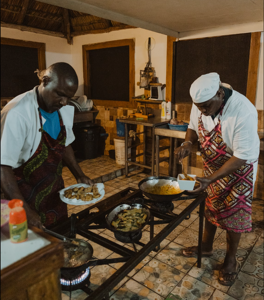 The Bemugi's kitchen team cooking before the fire