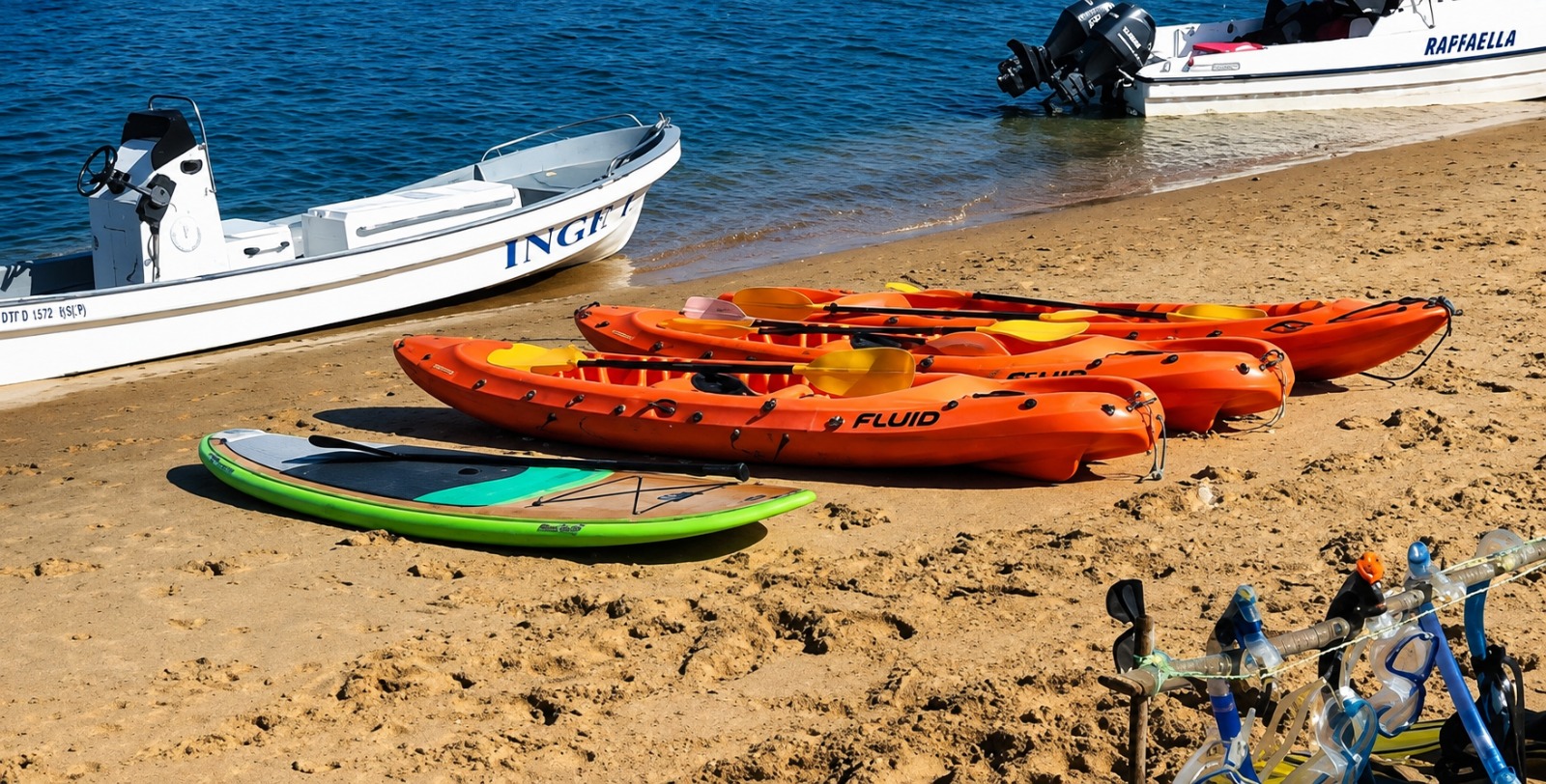 Bright kayak in turquoise shallows beside mangroves and white sand